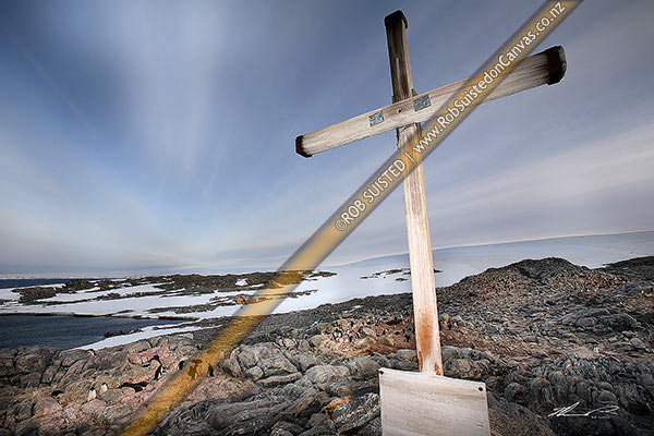 Photo of 1913 Memorial Cross for Belgrave Ninnis and Xavier Mertz, Azimuth Hill, Mawson's Huts and Boat Harbour behind, Cape Denison, Commonwealth Bay, Antarctica, Antarctica Region, Antarctica