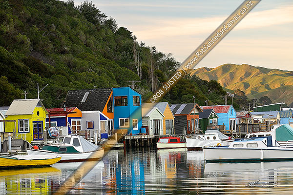 Photo of Colourful Mana boatsheds and boats in the water of Pauatahanui Inlet on a calm evening, Paremata, Porirua City, Wellington Region, New Zealand (NZ)