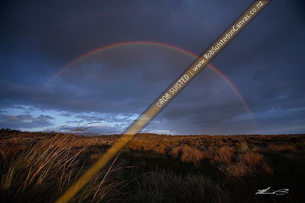 Photo of Full arch rainbow over coastal land at the Wairaurahiri River Mouth on a moody evening. Fiordland coast, Waitutu Forest, Fiordland, Southland, Southland Region, New Zealand (NZ)