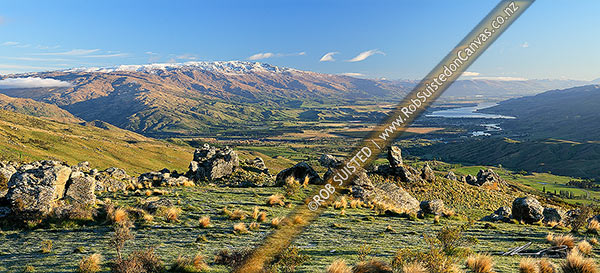 Photo of Panorama looking down on Cromwell, Ripponvale, the Clutha River Valley and Lake Dunstan from the Carrick Range. Pisa Range left. Rock tors, Bannockburn, Central Otago, Otago Region, New Zealand (NZ)