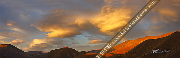 Photo of Lenticular clouds gathering in evening sunset over Lindis Pass and the Dunstan Range, signalling coming bad weather and winds. Panorama, Lindis Pass, MacKenzie, Canterbury Region, New Zealand (NZ)