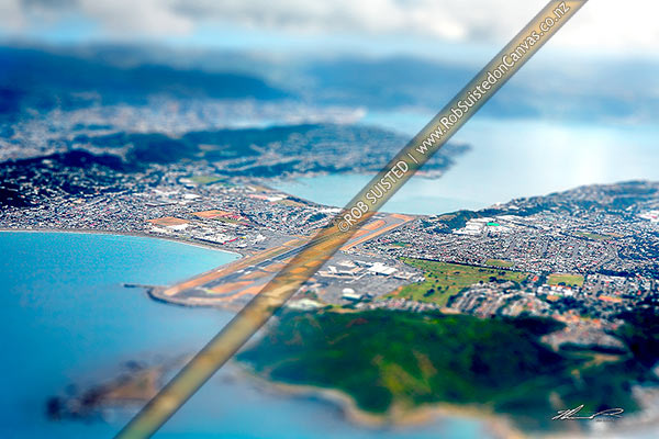 Photo of Fake miniature photo of Wellington Airport aerial view, with city and harbour behind. Lyall Bay left, Evans Bay centre, showing Rongotai, Kilbirnie, Strathmore and Miramar, Wellington, Wellington City, Wellington Region, New Zealand (NZ)