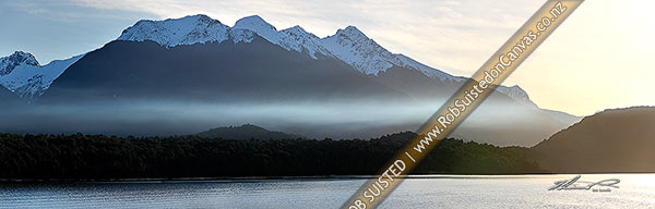 Photo of Lake Manapouri at dusk, with snow capped Kepler Mountains behind, in winter. Panorama, Manapouri, Southland, Southland Region, New Zealand (NZ)