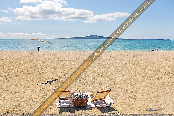 Photo of Mission Bay Beach with two empty picnic chairs and basket looking out towards Rangitoto Island and Motukorea Channel, Mission Bay Beach, Auckland City, Auckland Region, New Zealand (NZ)