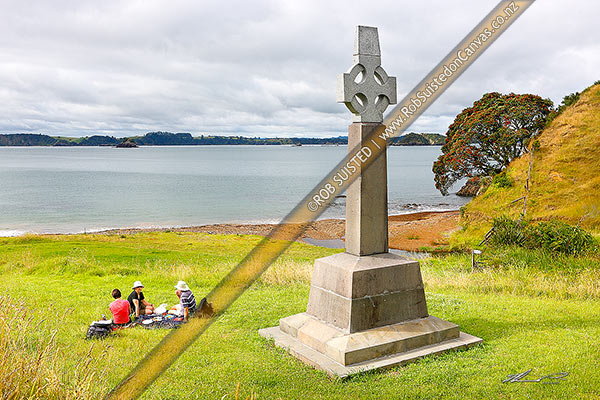 Photo of Marsden Cross and picnickers in Hohi (Oihi) Bay, where Reverend Samuel Marsden preached his 1st sermon Christmas Day 1814, below Rangihoua Pa, Kerikeri, Far North, Northland Region, New Zealand (NZ)