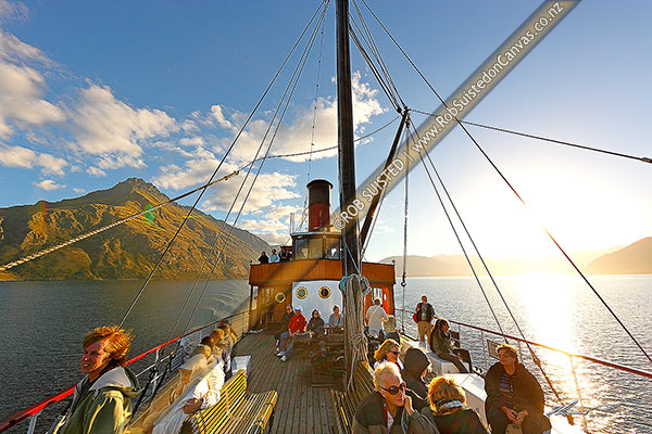 Photo of TSS Earnslaw, an historic steamship carrying tourists on Lake Wakatipu. Walter Peak (1800m) behind. Evening light, Queenstown, Queenstown Lakes, Otago Region, New Zealand (NZ)