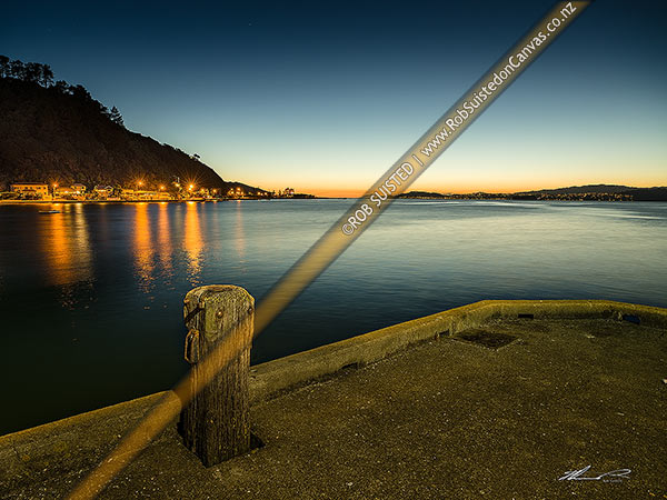 Photo of Days Bay wharf and Wellington Harbour entrance at sunset. Eastbourne centre and Wellington City at right, Days Bay, Hutt City, Wellington Region, New Zealand (NZ)