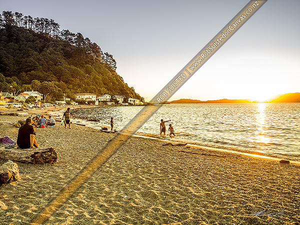 Photo of Days Bay at dusk on a perfect evening. Families and friends enjoying a warm evening and swimming in Wellington Harbour, Days Bay, Hutt City, Wellington Region, New Zealand (NZ)