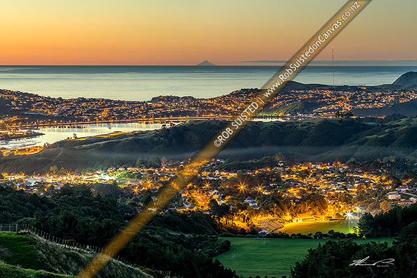 Photo of Porirua City with Mt Taranaki visible on horizon. Porirua CBD far left, Titahi Bay centre, Porirua East bottom right. Twilight, Porirua, Porirua City, Wellington Region, New Zealand (NZ)