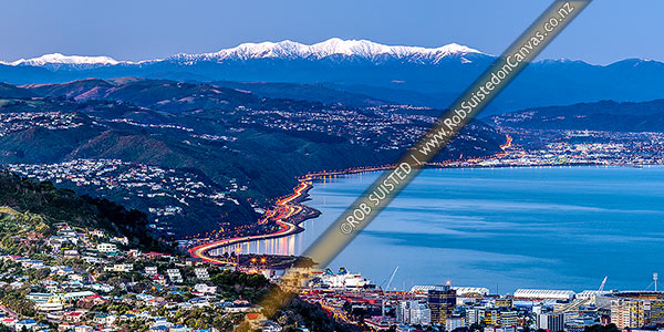 Photo of Wellington city with Tararua Ranges above. Looking along SH1/SH2 to the Hutt Valley beyond. Wadestown, Thorndon and Kaiwharawhara in foreground. Hutt City and Petone beyond. Winter dusk panorama, Wellington, Wellington City, Wellington Region, New Zealand (NZ)