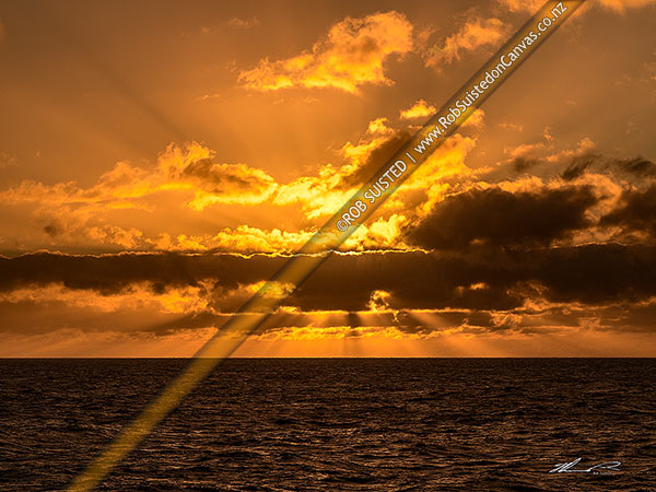 Photo of Southern Ocean sunset. Sun behind clouds creating crepuscular sun rays, Southern Ocean, Antarctica, Antarctica Region, Antarctica
