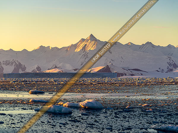 Photo of Mount (Mt) Herschel (3335m) standing in the Admiralty Mountains. First climbed in 1967 by Sir Ed Hillary. Honeycomb ridge and Moubray Bay in foreground, Ross Sea, Antarctica, Antarctica Region, Antarctica