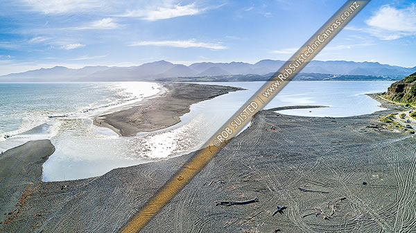 Photo of Lake Ferry (Onoke) and outlet into Palliser bay. Remutaka (Rimutaka) Forest Park and Ranges beyond. Aerial panorama, Lake Ferry, South Wairarapa, Wellington Region, New Zealand (NZ)