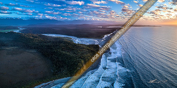 Photo of Poerua River mouth in Westland, with Hikimutu Lagoon and Saltwater Lagoon visible. Abut Head far right. Southern Alps beyond, at dusk. Aerial panorama, Harihari, Westland, West Coast Region, New Zealand (NZ)