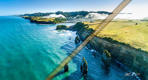 Photo of Tongaporutu River mouth on the North Taranaki coast, as morning inversion cloud flows down river valley. Aerial view looking north past the Three Sisters rocks.  Aerial view, Tongaporutu, New Plymouth, Taranaki Region, New Zealand (NZ)
