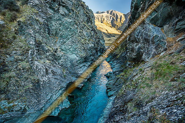 Photo of Sixteen Mile Gorge on the upper Shotover River, with Mt Lima (2310m) in the Richardson Mountains beyond. A dramatic cleft in rock carrying the Shotover River. Branches Station, Shotover River Valley, Queenstown Lakes, Otago Region, New Zealand (NZ)