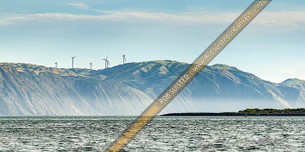 Photo of Porirua west coast, looking past Shingle Point Mana Island and 'The Bridge' towards Pipinui Point and Makara. Mill Creek wind farm. Panorama, Titahi Bay, Porirua City, Wellington Region, New Zealand (NZ)