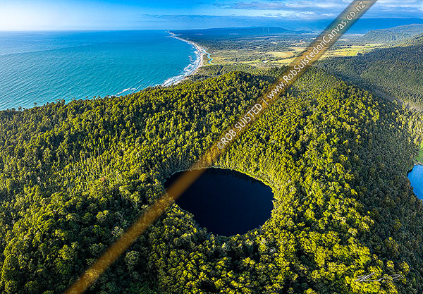 Photo of Un-named forest lake near Jacob's River Makawhio, looking north over the Manakaiaua River and Hunts Beach. Aerial view, Jacobs River, Westland, West Coast Region, New Zealand (NZ)