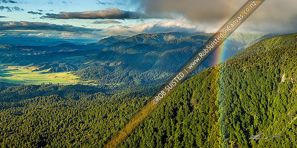 Photo of Ruahine Ranges forested foothills looking over the Kawhatau River valley (left), Hikurangi Range centre and Whanahuia Range right. Rainbow in panorama, Ruahine Forest Park, Manawatu, Manawatu-Wanganui Region, New Zealand (NZ)